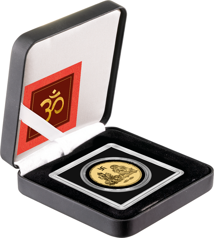 The coin in its capsule inside an open black presentation case, with a red Om card in the lid